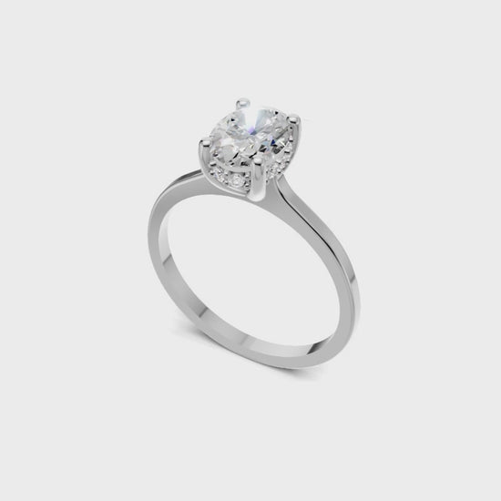 Halo Bloom Oval engagement ring with diamond halo and oval center stone by Duda Jewels.