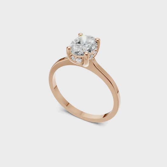 Halo Bloom Oval engagement ring with diamond halo and oval center stone by Duda Jewels.